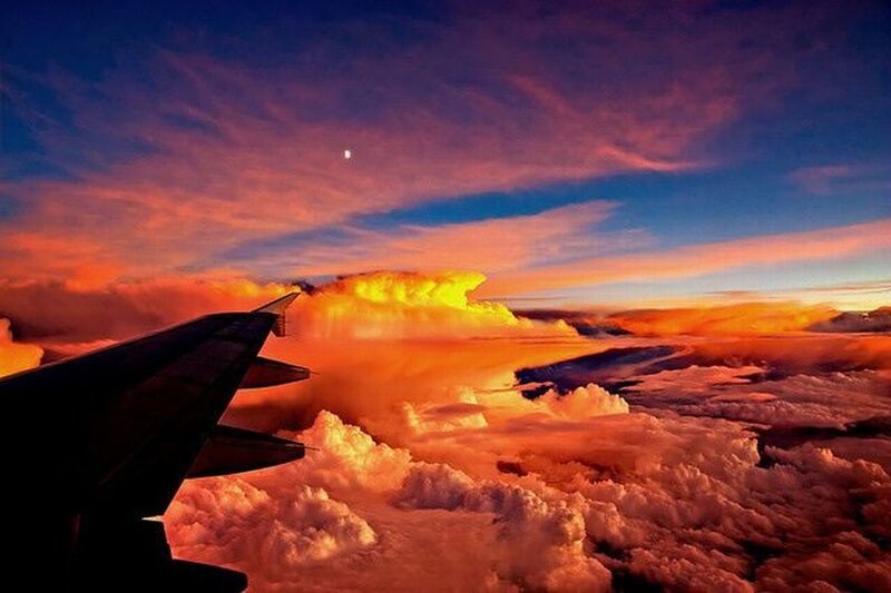Airplane Wing Above Clouds — Orange