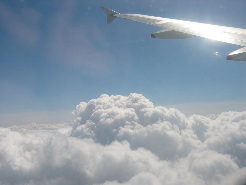 Airplane Wing Above Clouds — White, Serene, Afternoon