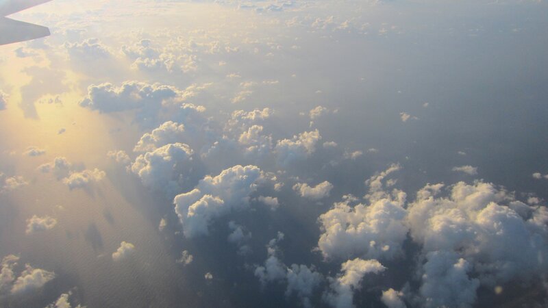 Airplane Wing Above Clouds — White, Serene, Sunset, Photograph