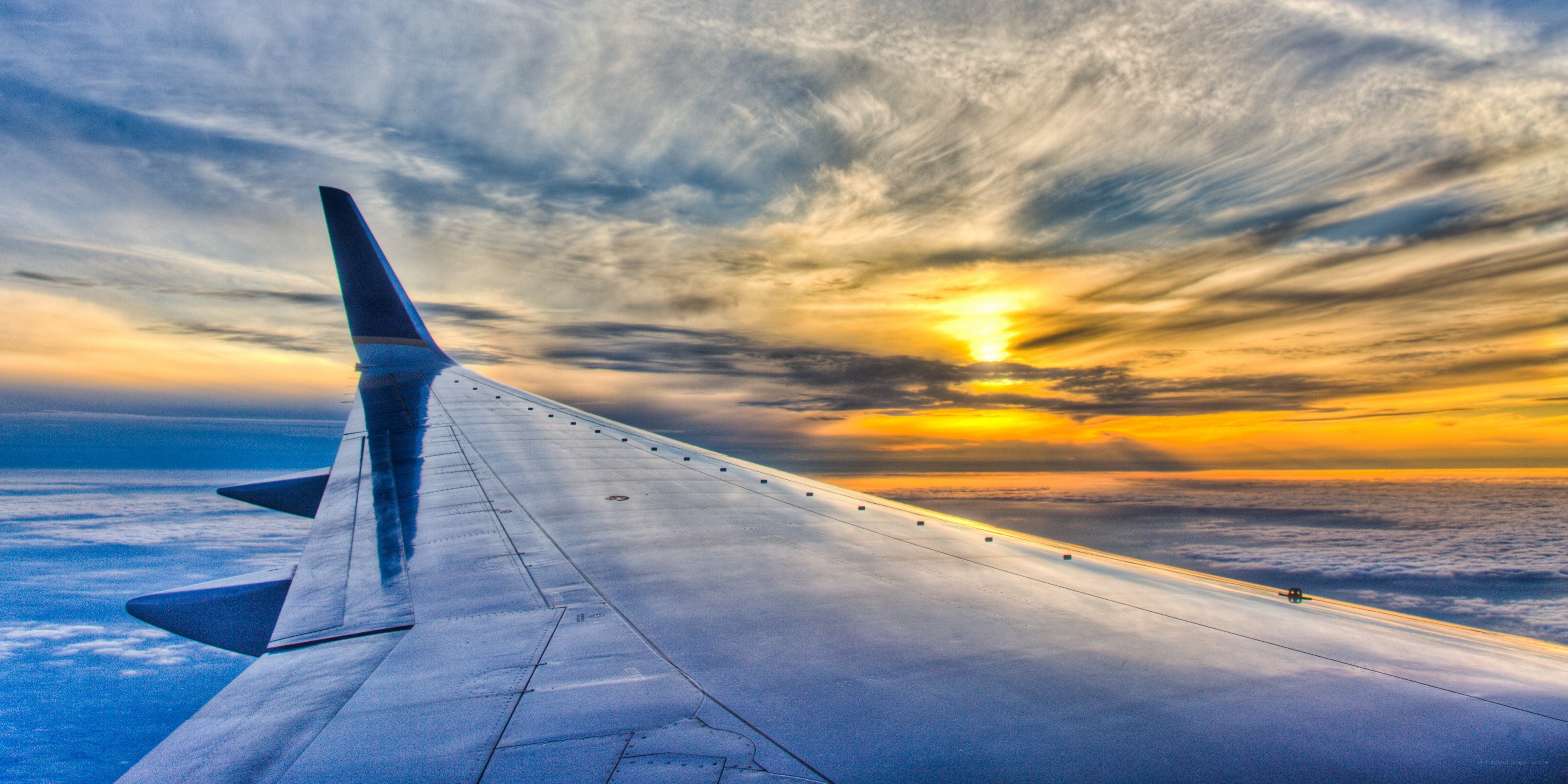 Airplane wing at sunset