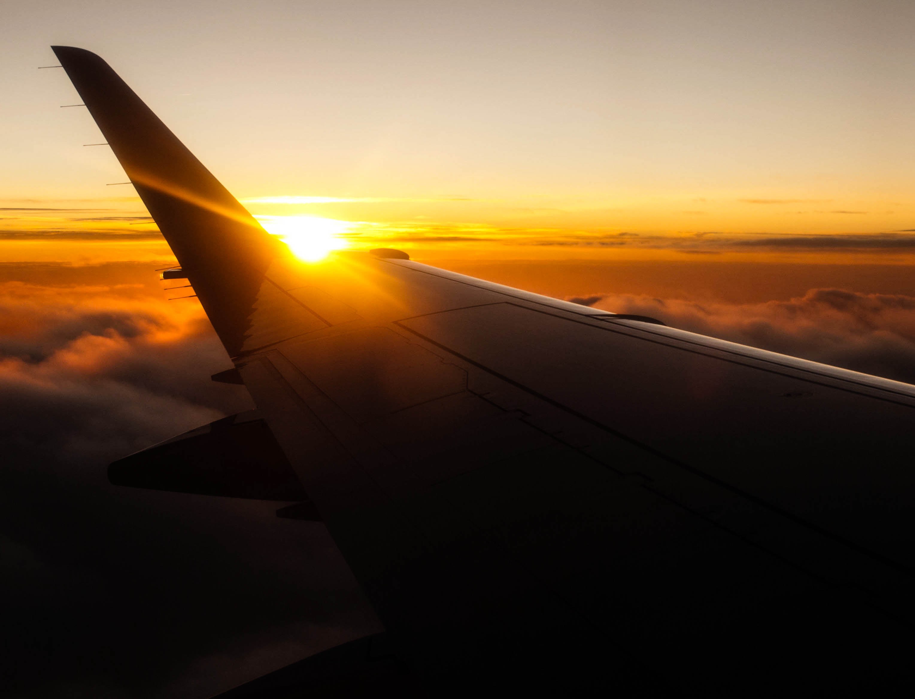 Airplane wing at sunset