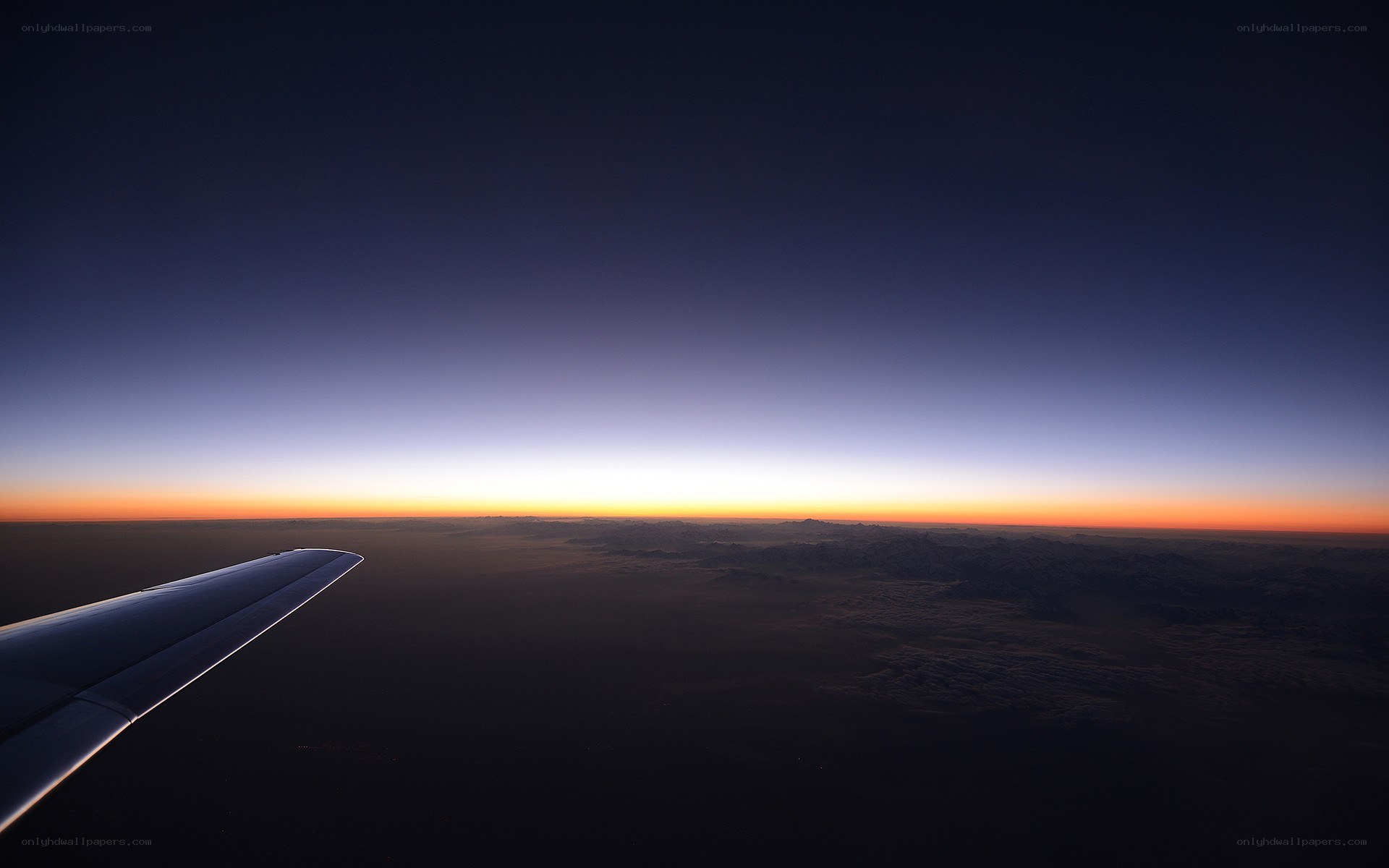 Airplane wing at sunset
