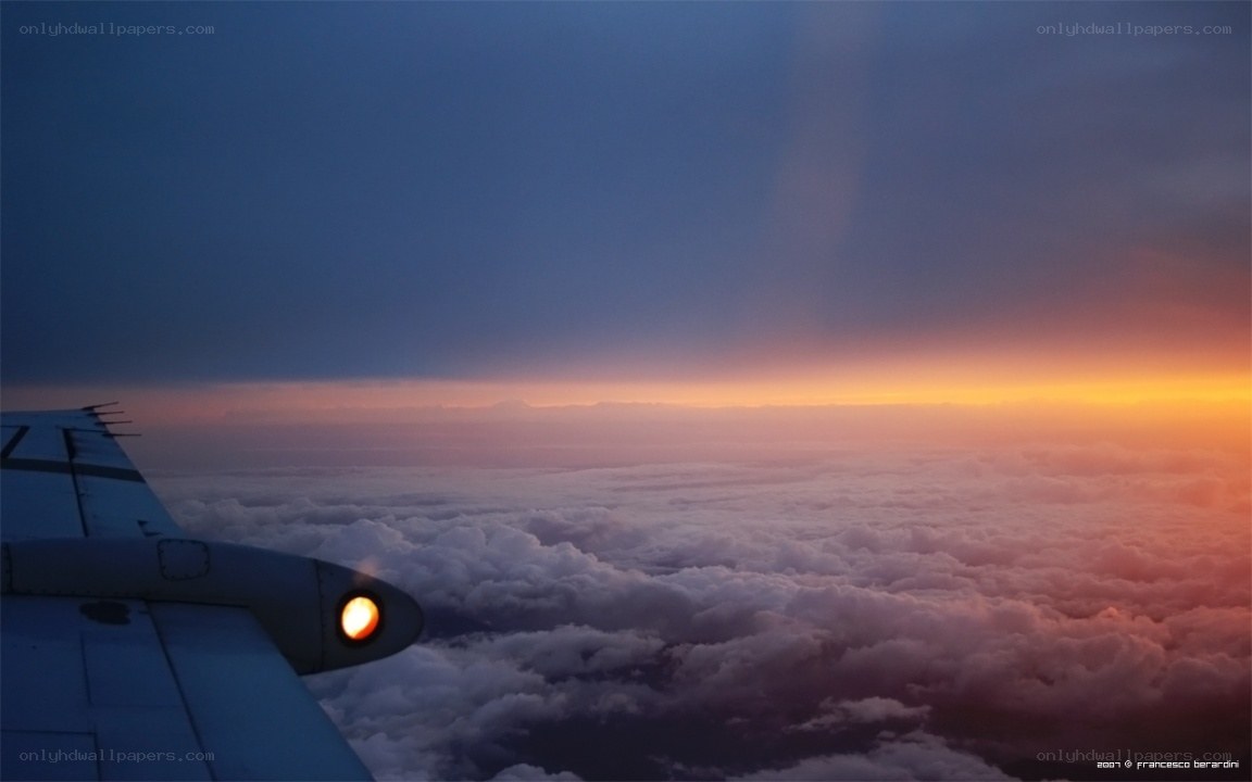 Airplane wing at sunset