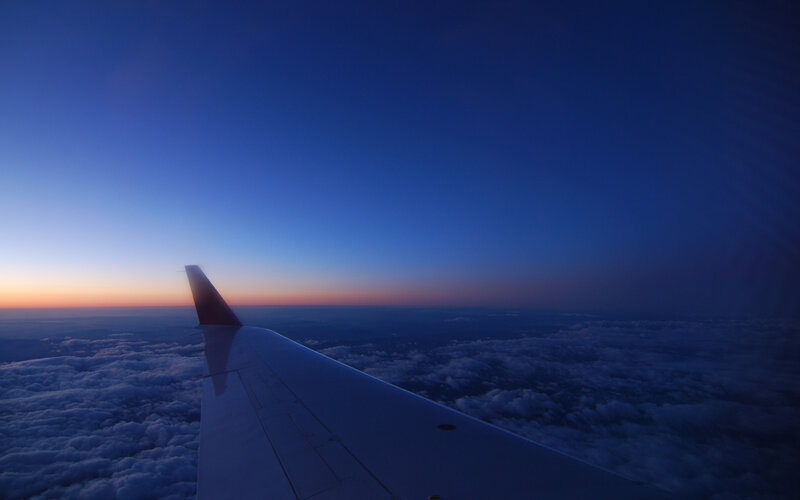 Airplane wing at sunset