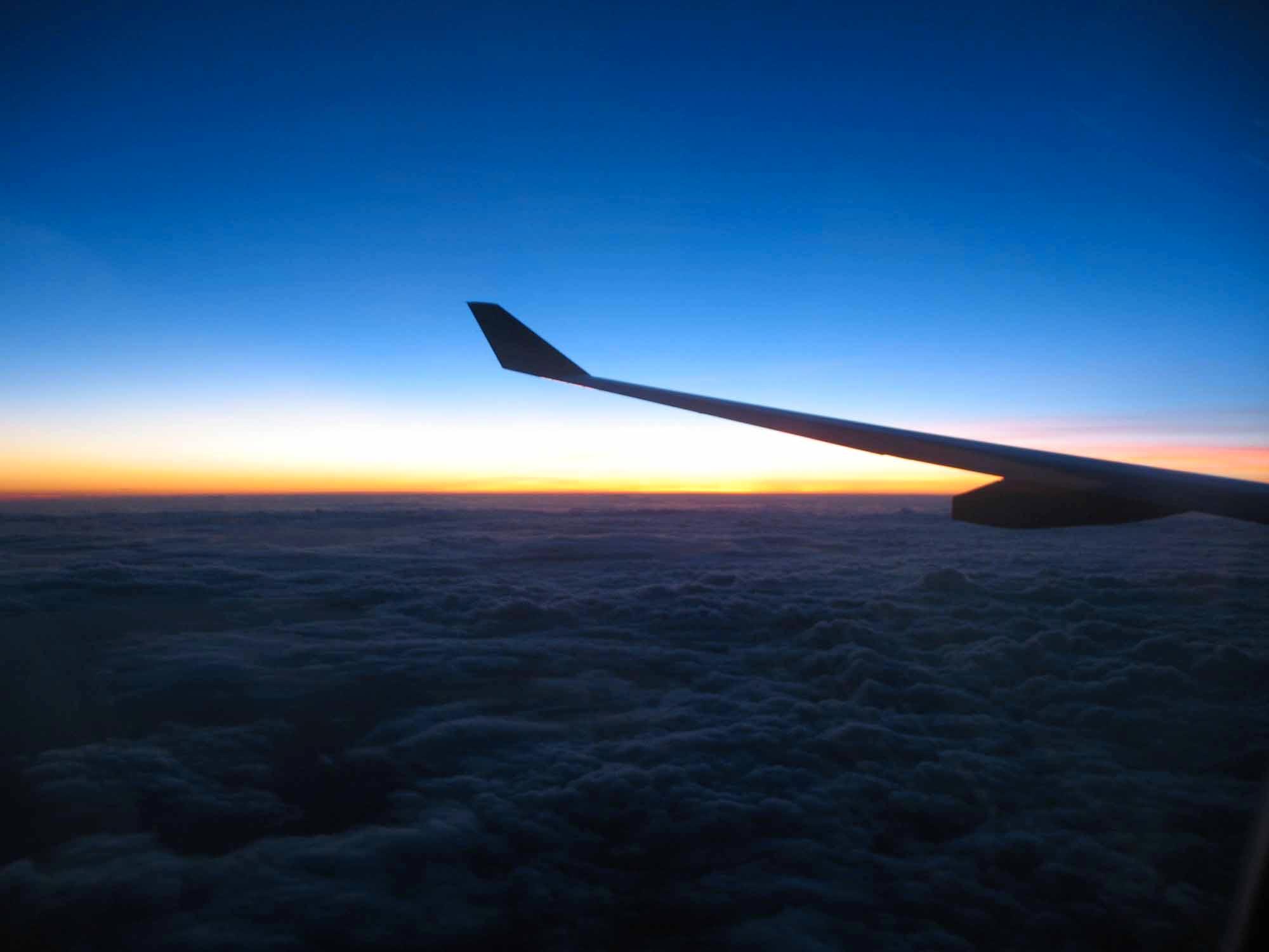 Airplane wing at sunset