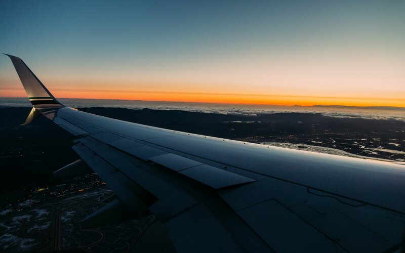 Airplane Wing at Sunset — Orange, Serene, Photograph, Clouds, City Lights