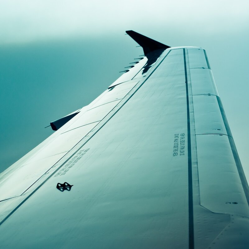 airplane wing in cloudy sky