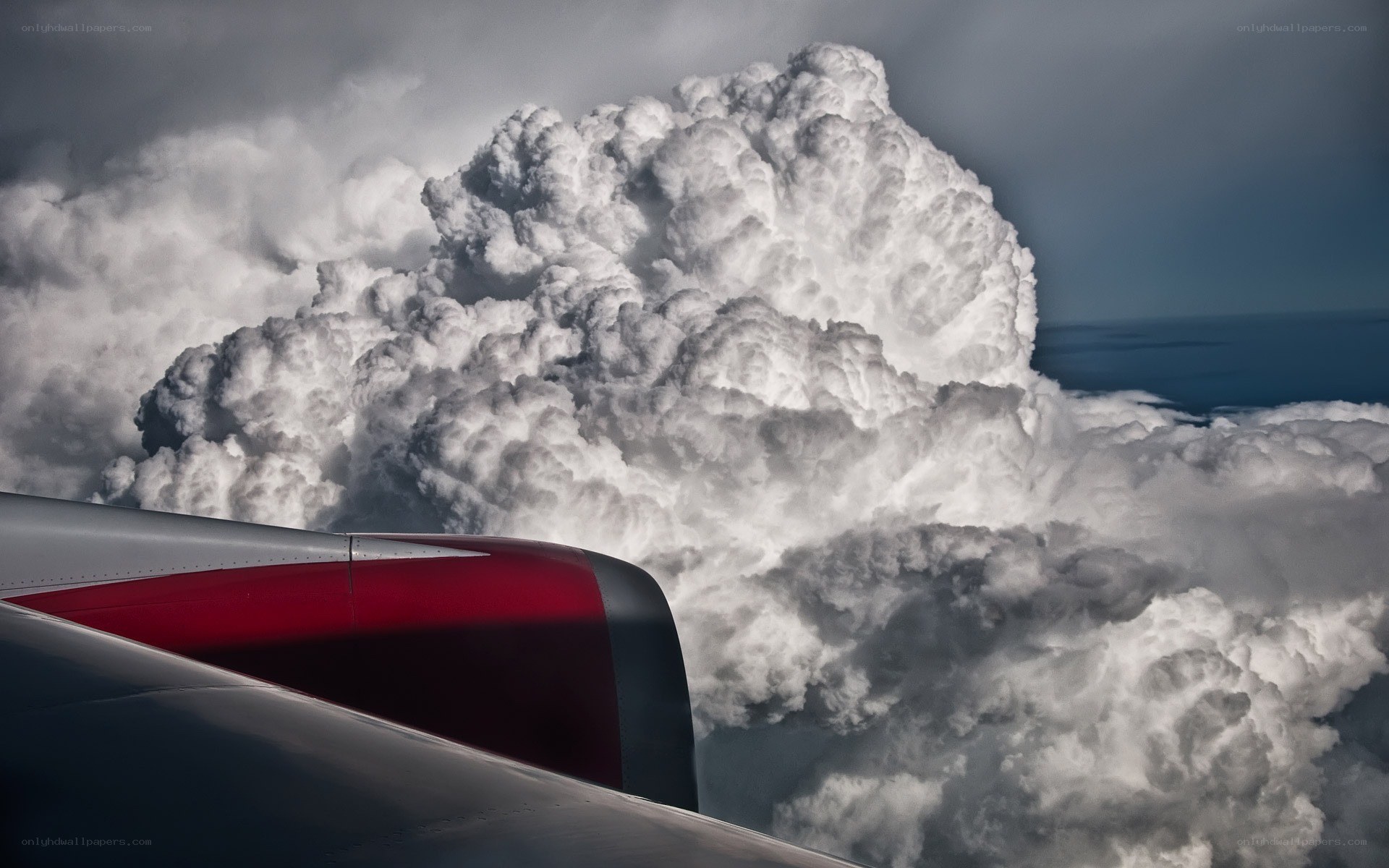 Airplane wing near storm cloud