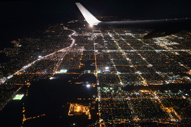 Airplane Wing over City — Black