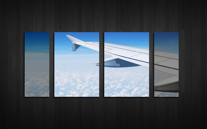 airplane wing over clouds
