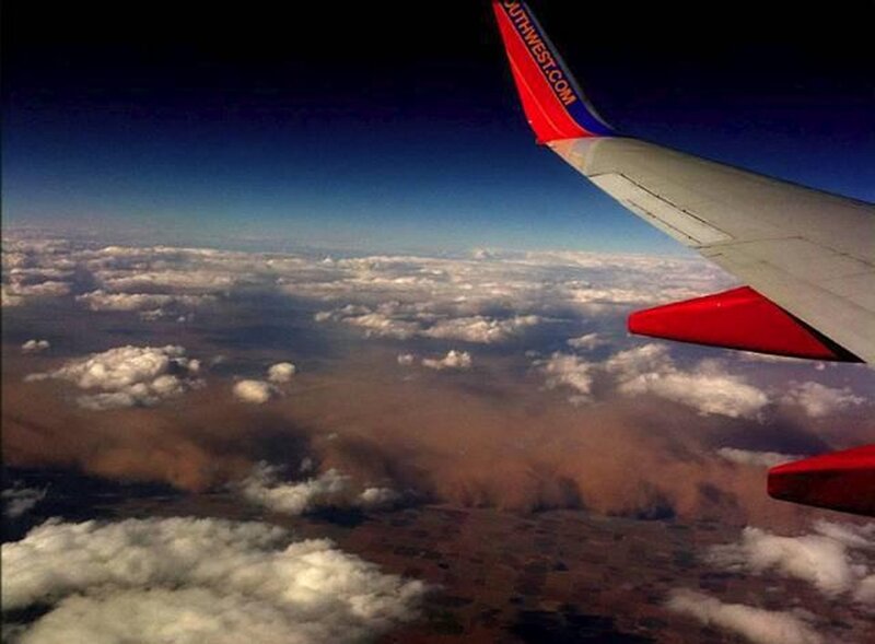 Airplane Wing over Clouds — Blue, Dramatic