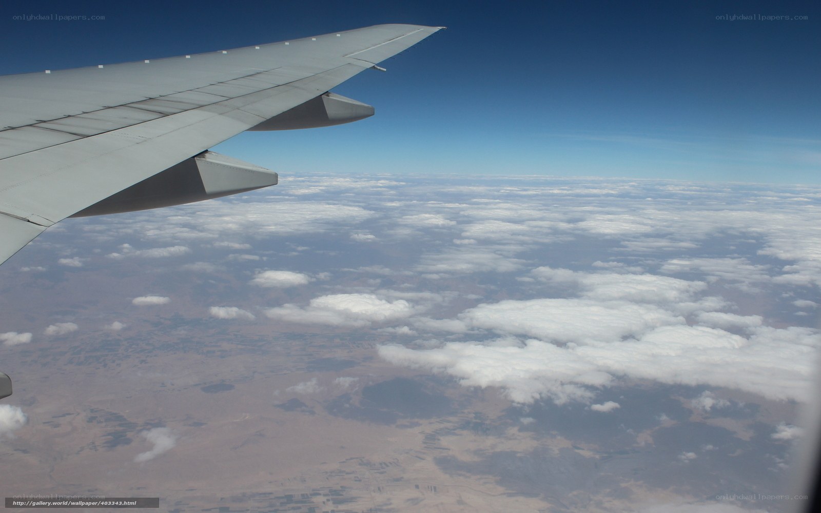 airplane wing over clouds