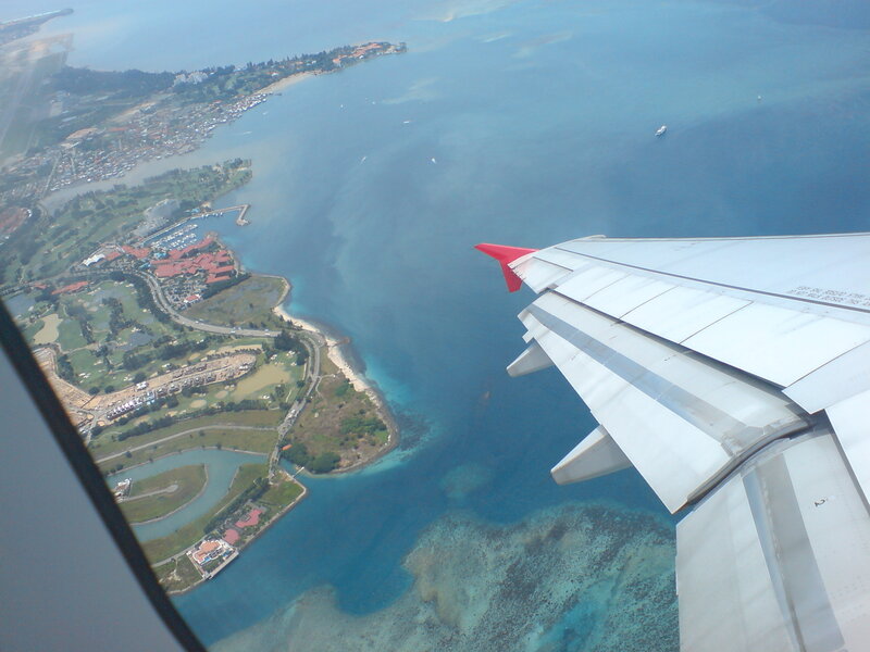 airplane wing over coastal area
