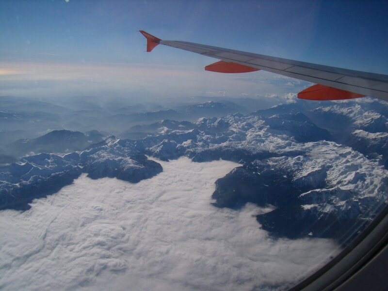 Airplane Wing over Mountains — Blue