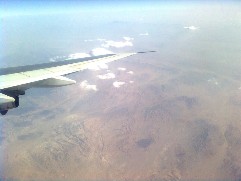 Airplane Wing over Mountains — Brown