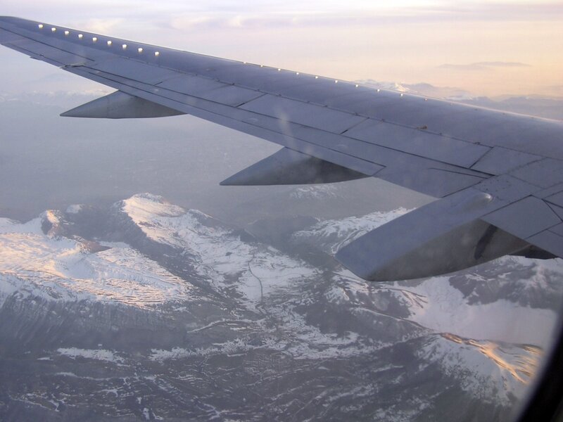 Airplane Wing over Mountains — Gray