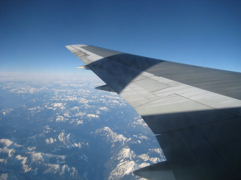 airplane wing over mountains