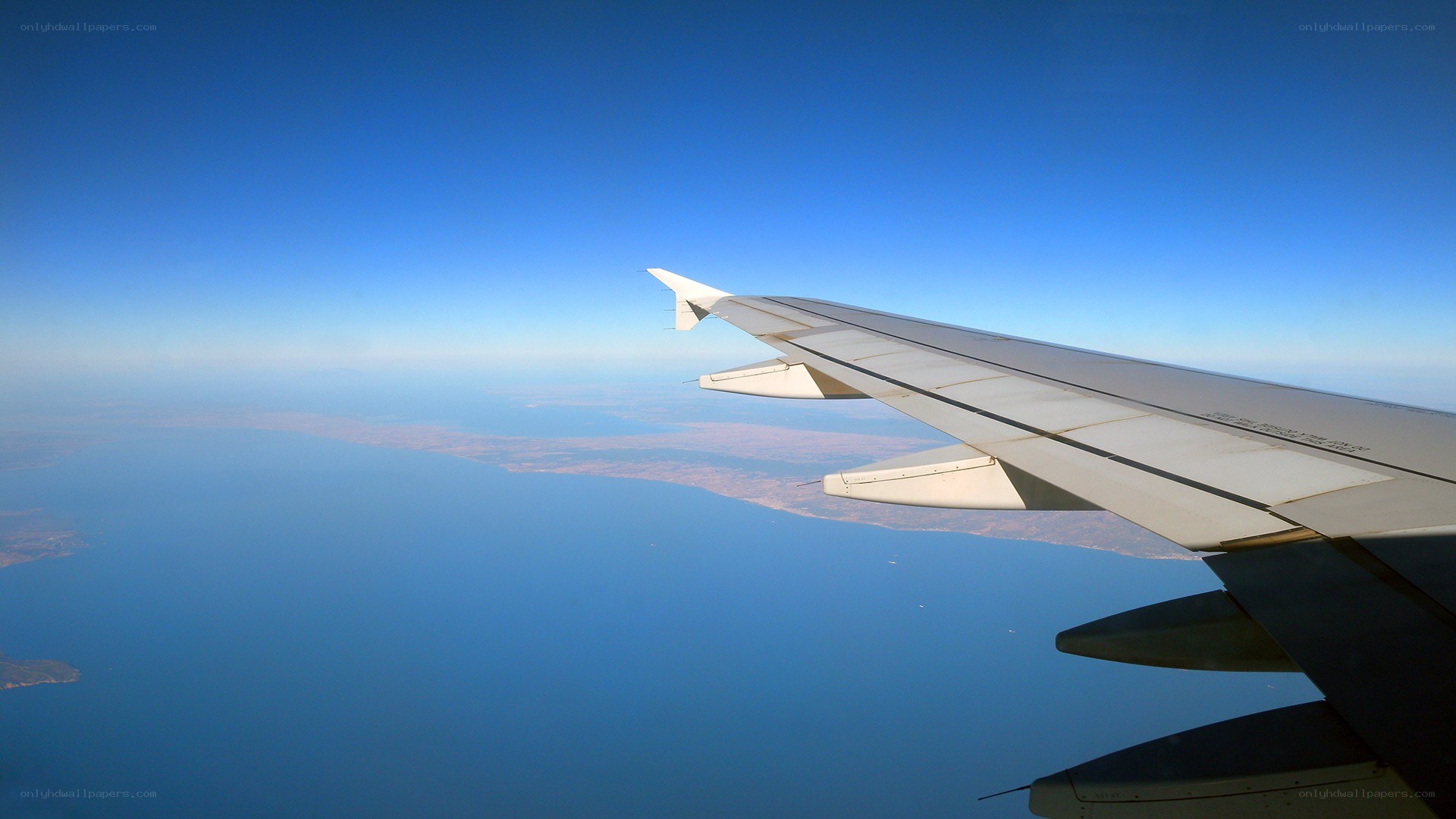 Airplane wing over sea
