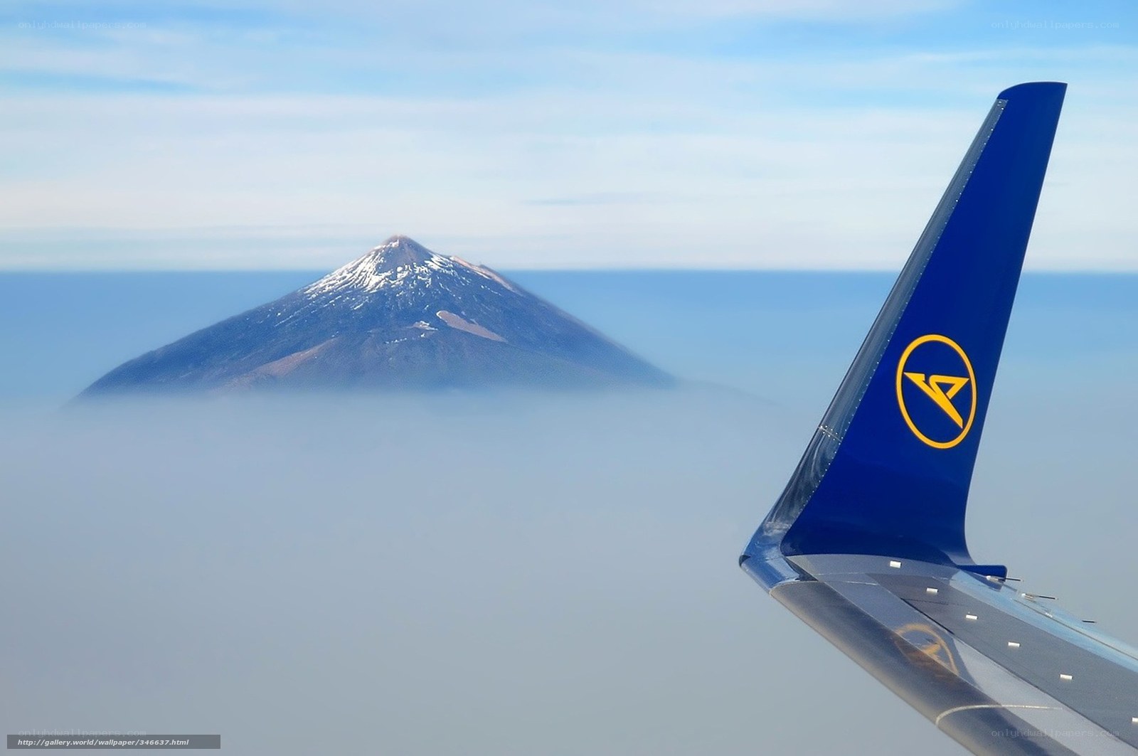 Airplane wing with volcano view