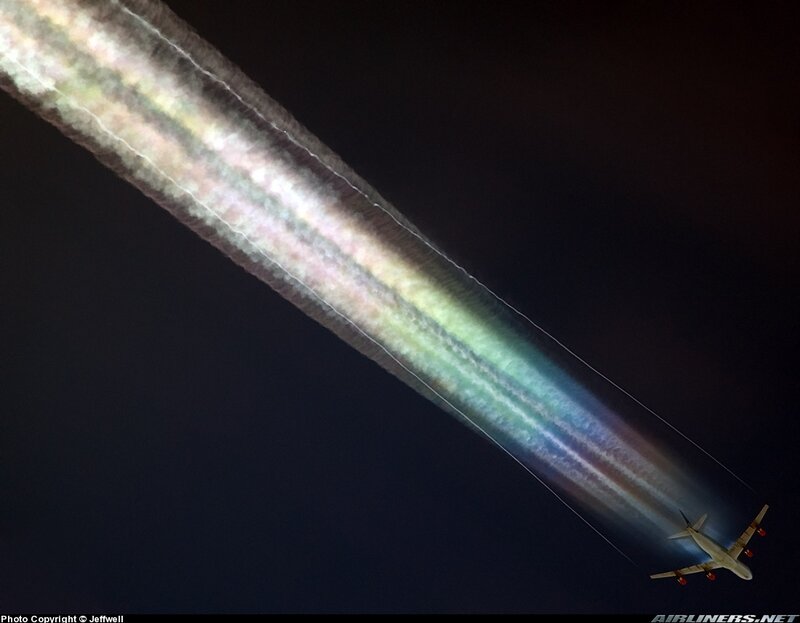 Airplane with colorful contrail