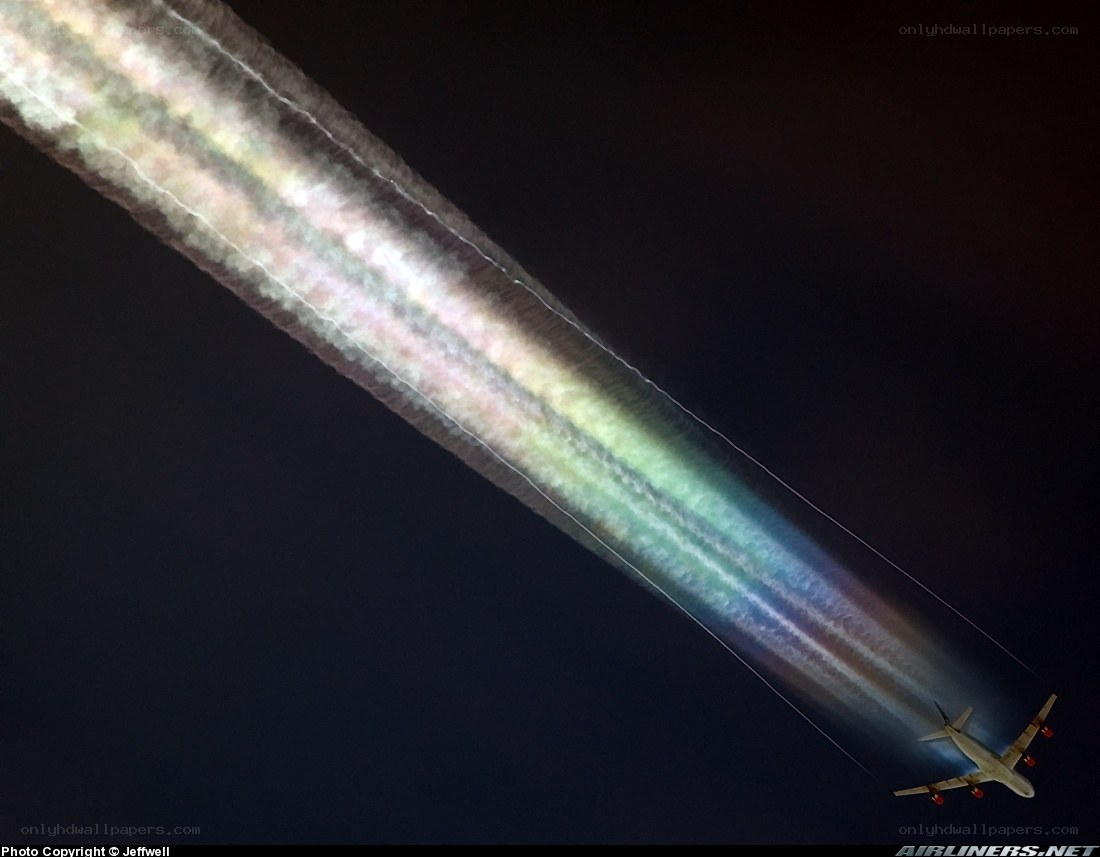 Airplane with colorful contrail