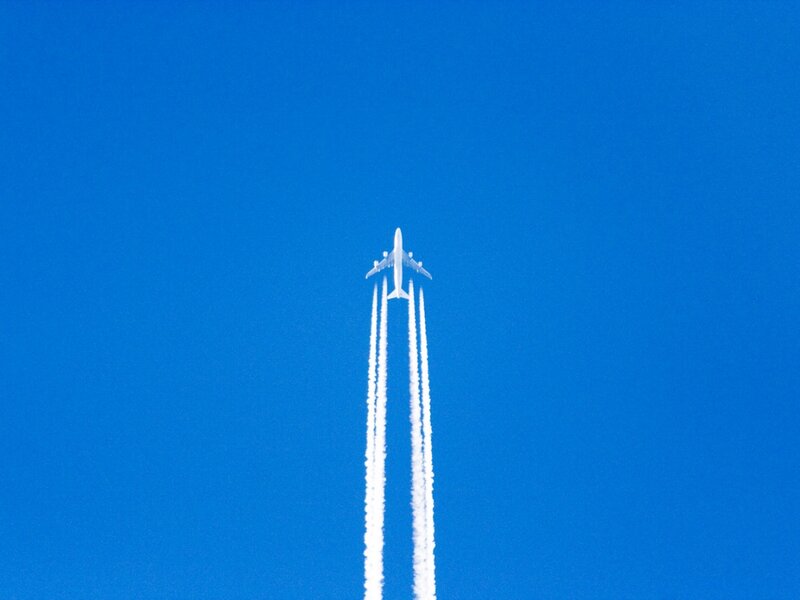 Airplane with Contrails — Blue
