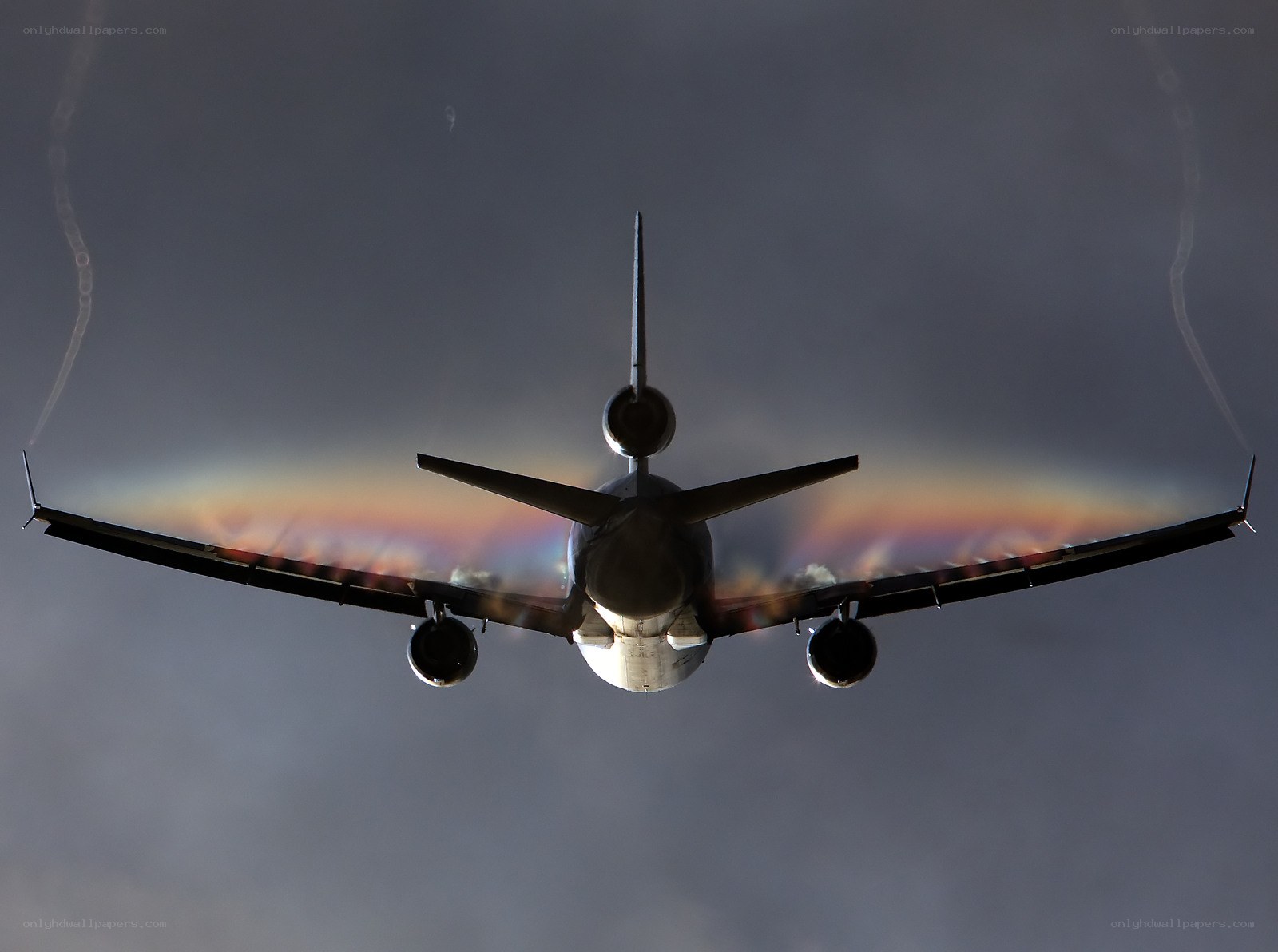 airplane with vapor trails
