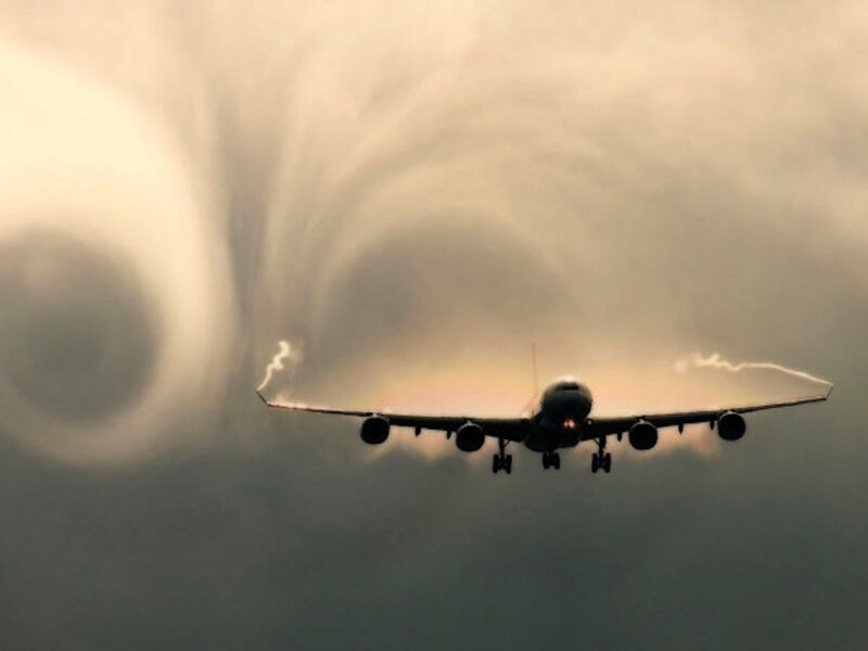 Airplane with Wingtip Vortices — Gray, Dramatic