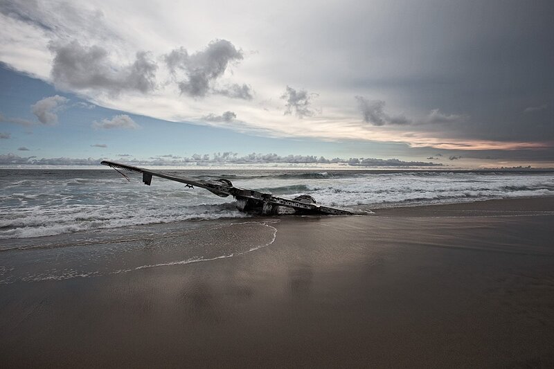 Airplane Wreckage on Beach — Gray