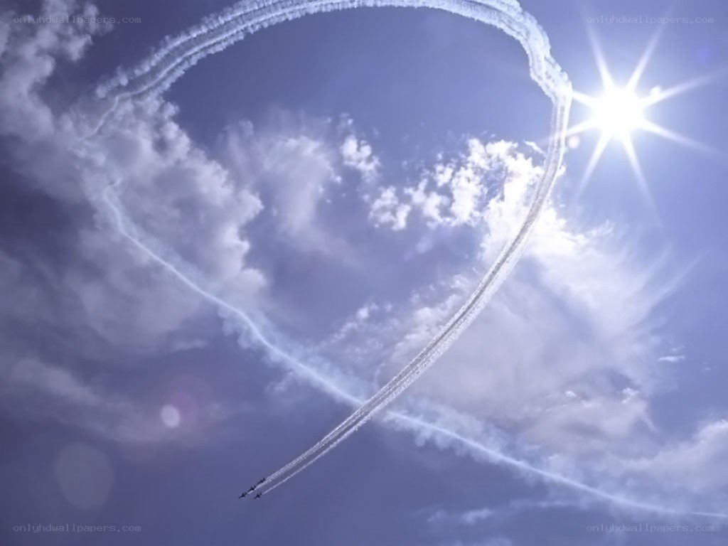 Airplanes drawing heart in sky
