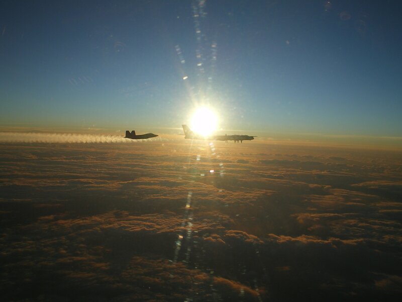 Airplanes flying over clouds at sunset