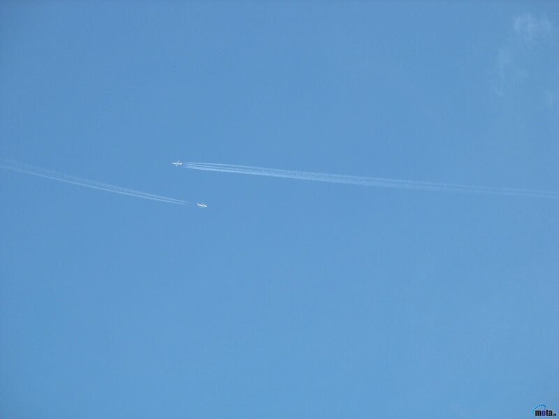Airplanes leaving contrails in blue sky