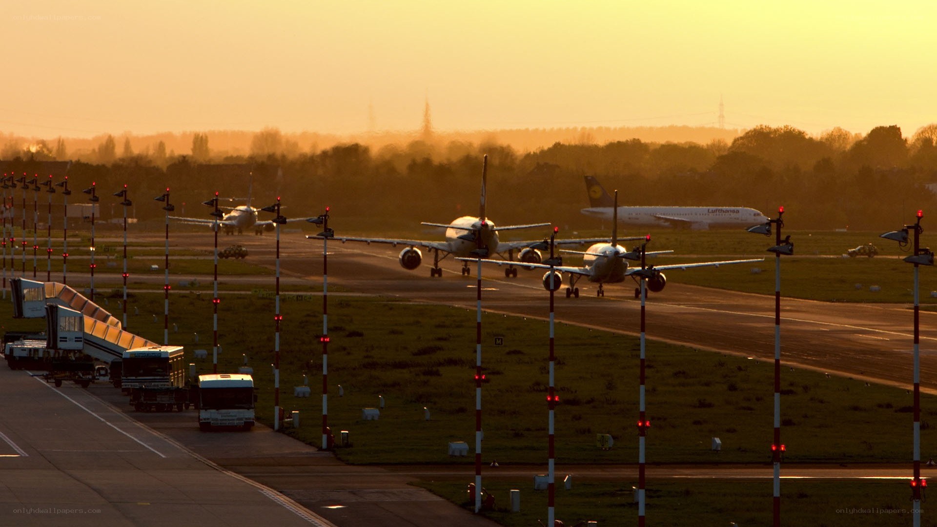 Airplanes on a runway at sunset