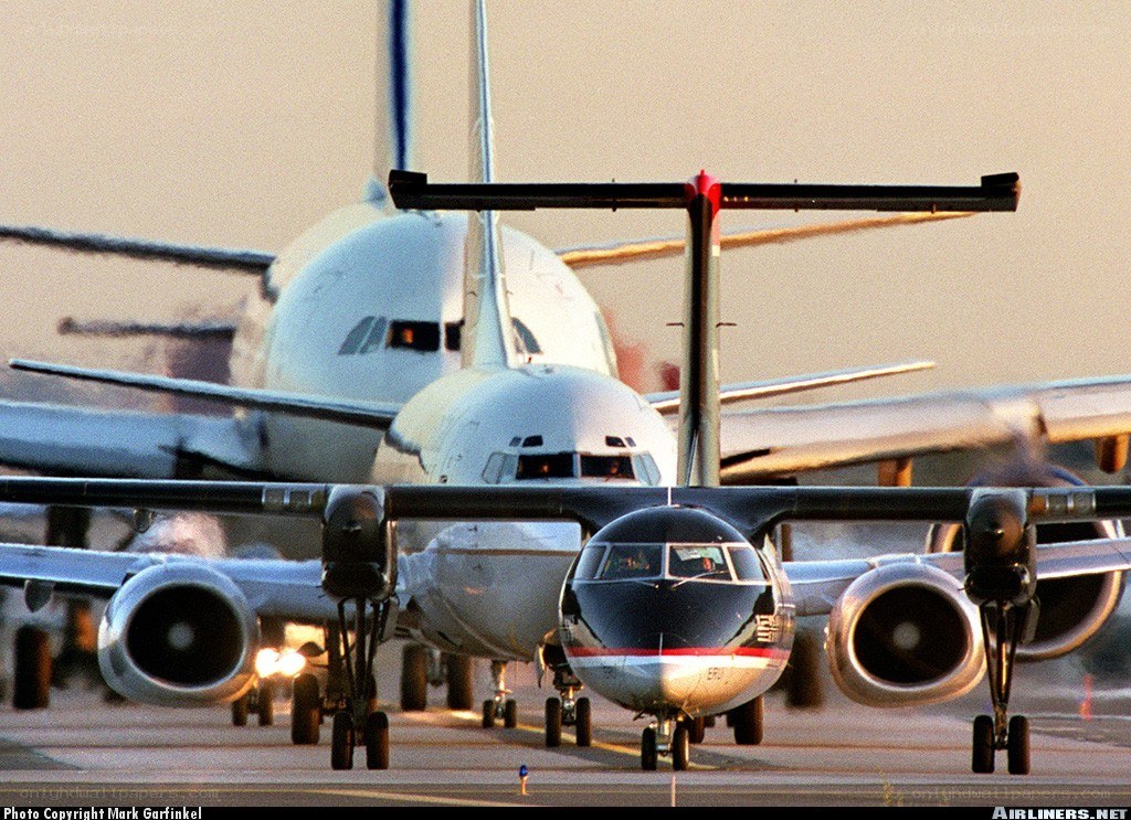 Airplanes on a runway at sunset