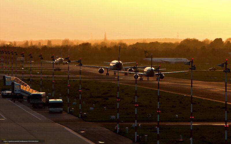 Airplanes on runway at sunset