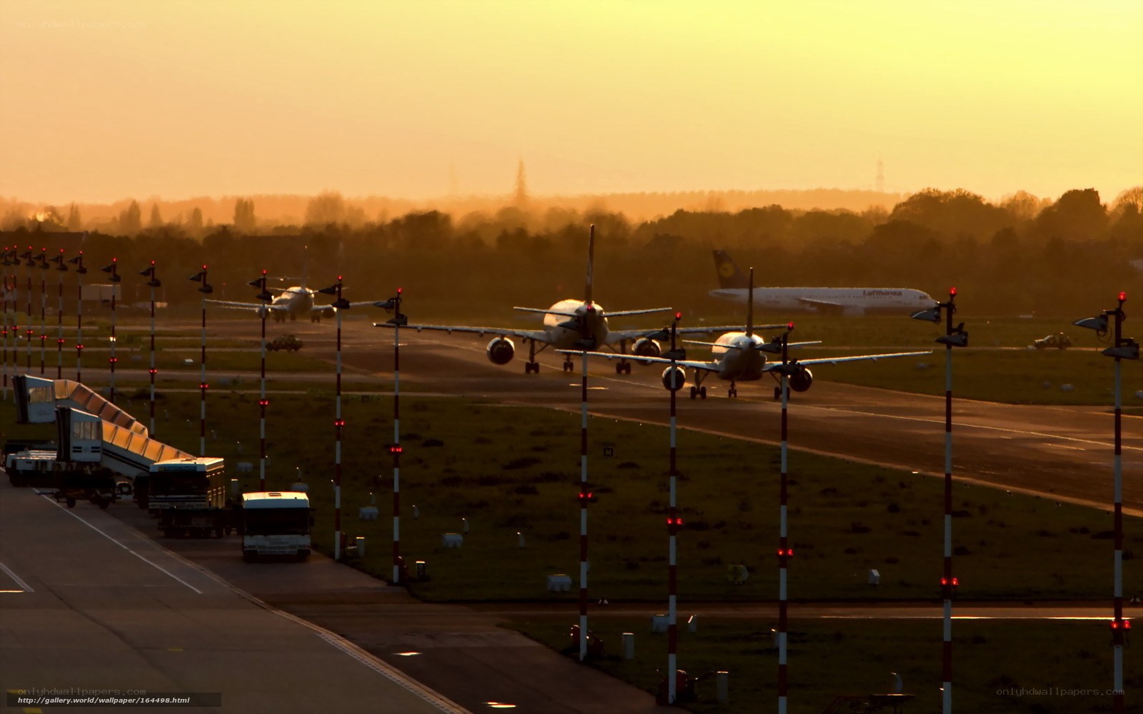 Airplanes on runway at sunset