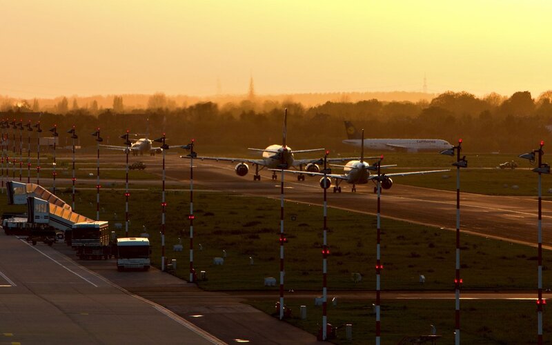 Airplanes on the tarmac at sunset