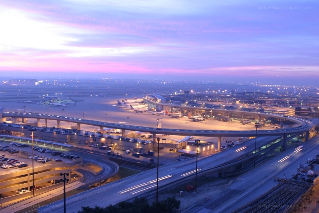 airport at dusk with planes