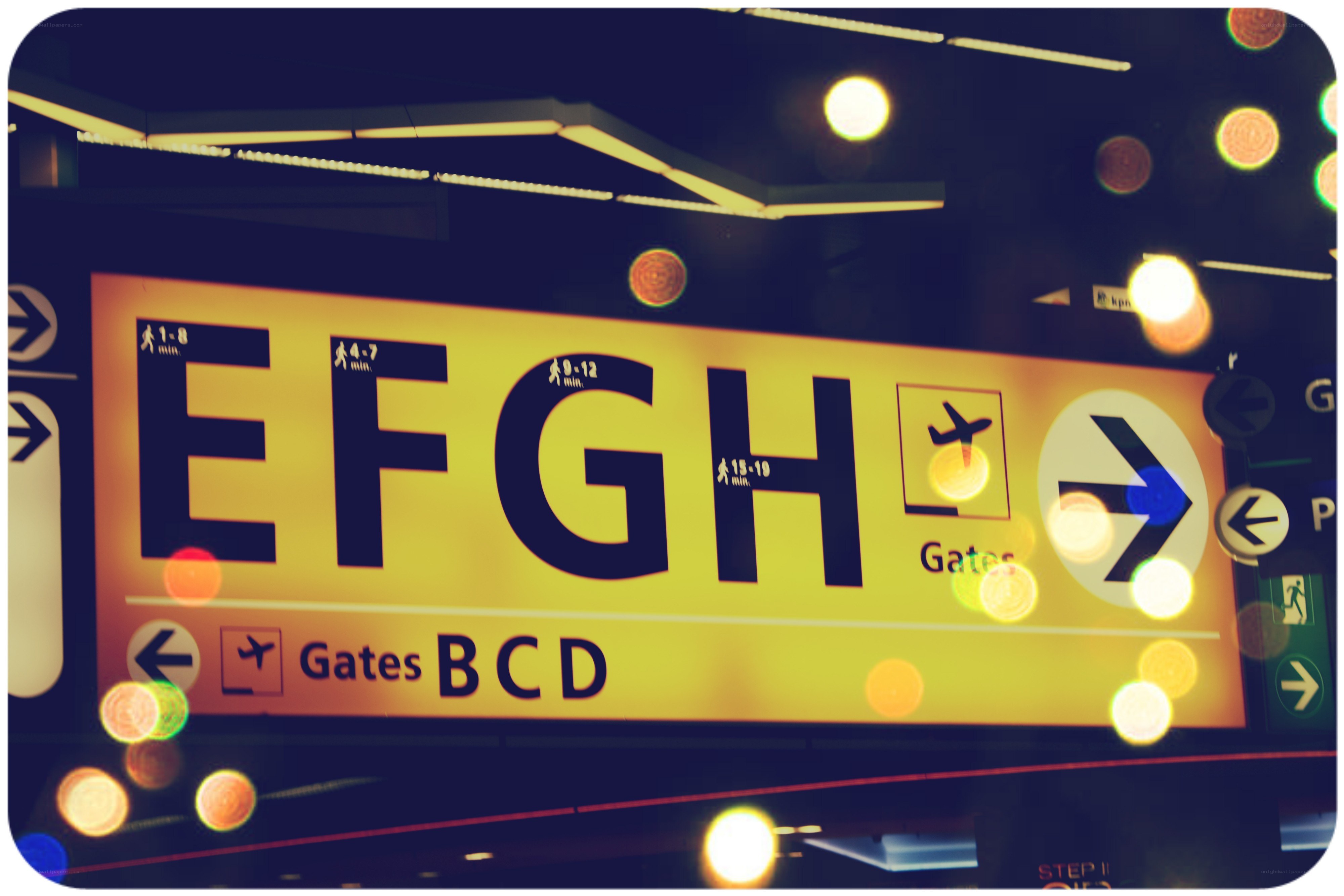 Airport gate sign with bokeh lights