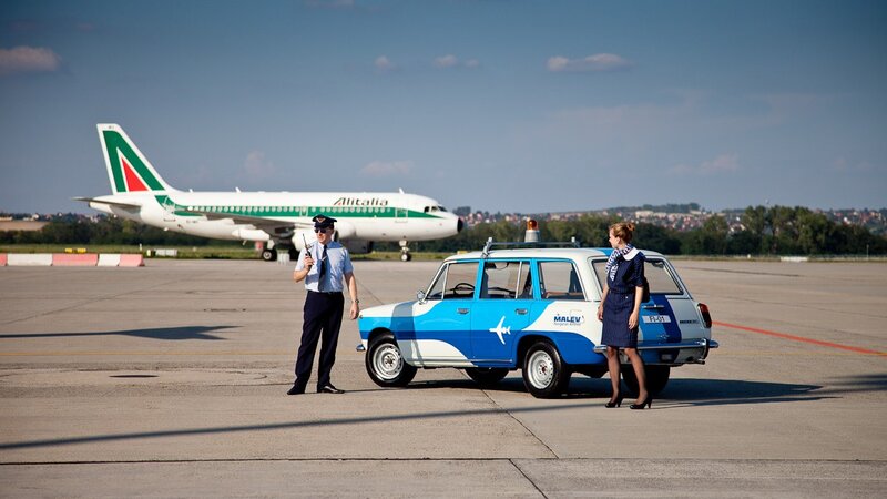 Airport ground crew with Alitalia plane