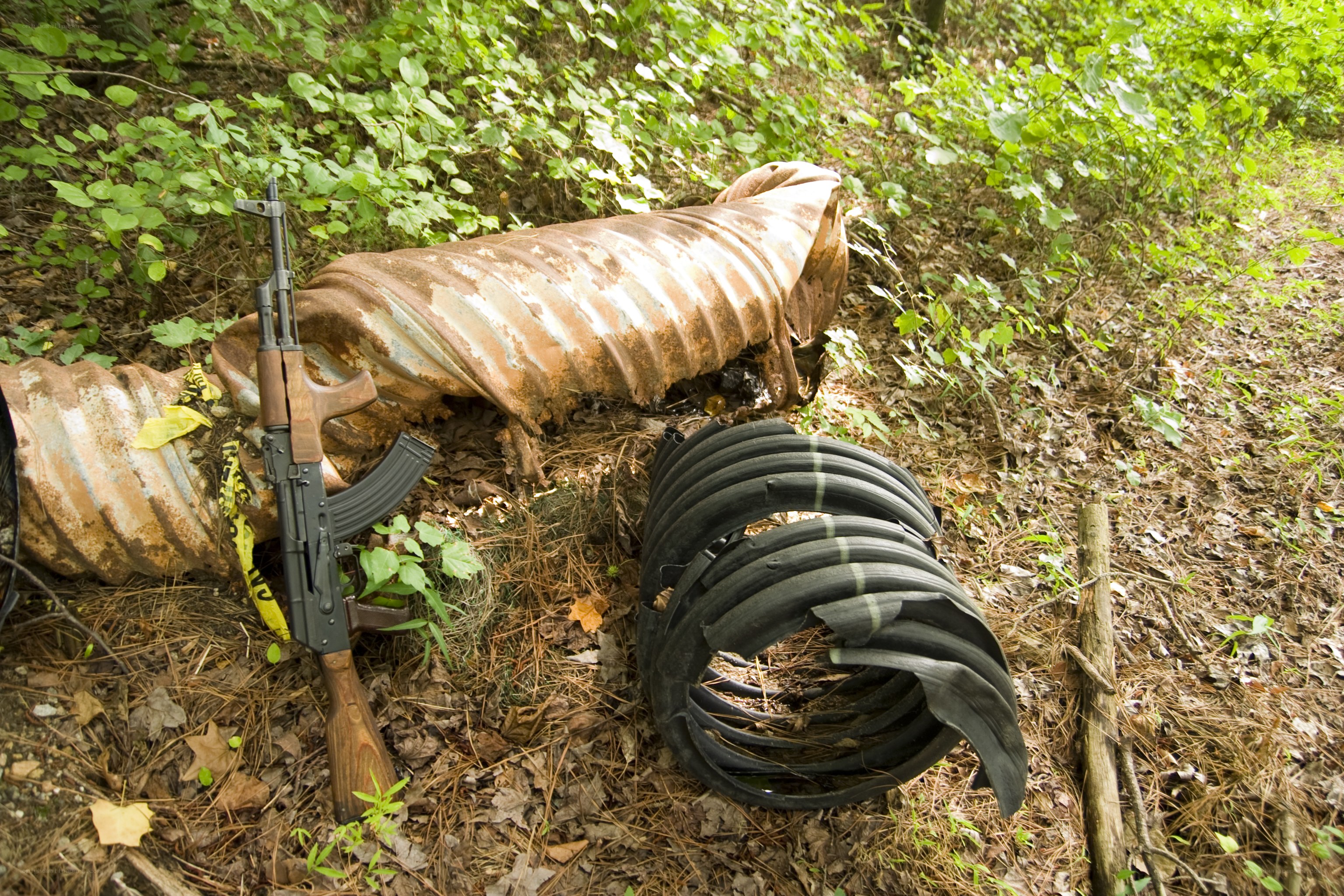AK-47 and hose in forest