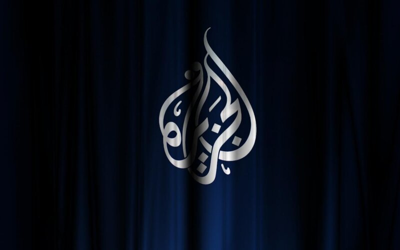 Al Jazeera logo on curtain