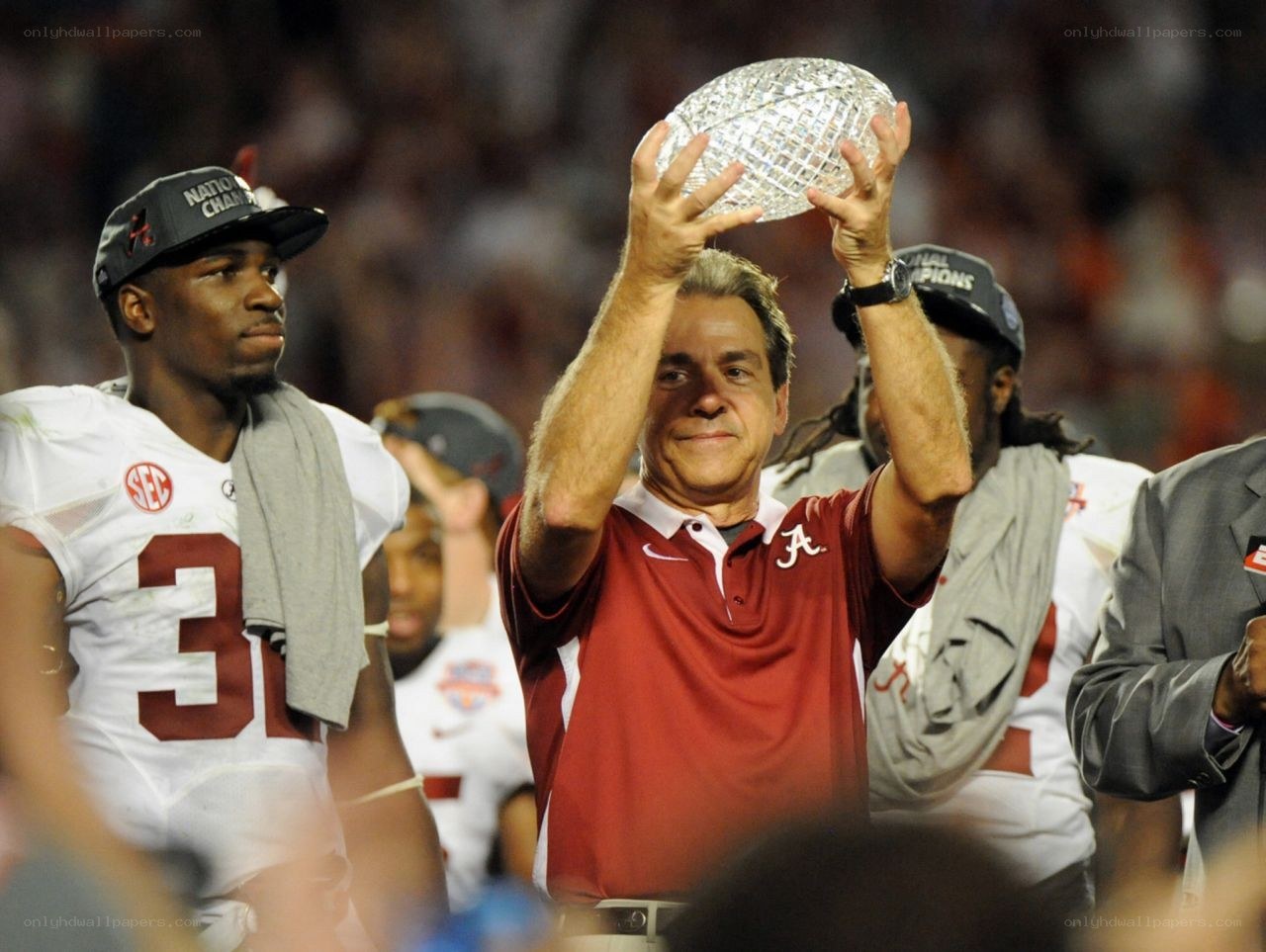 Alabama coach holds trophy