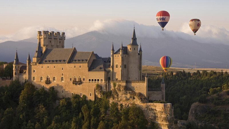 Alcazar of Segovia with hot air balloons