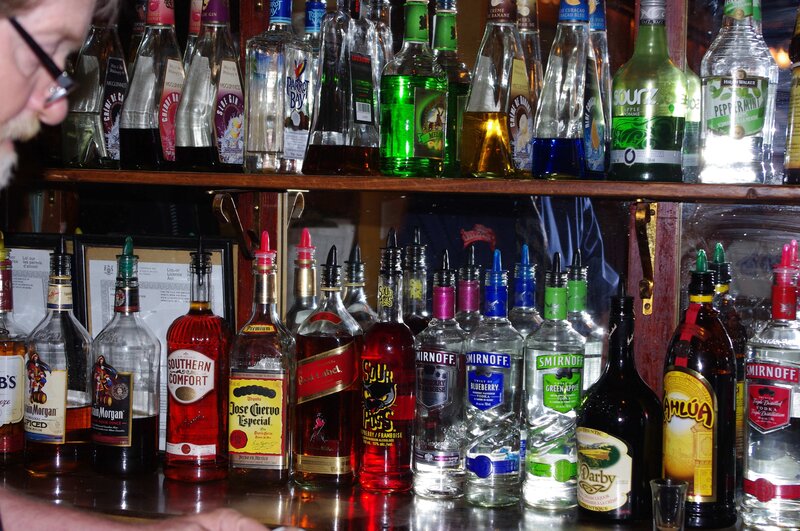alcohol bottles on bar shelves