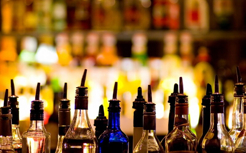 Alcohol Bottles on Bar — Yellow