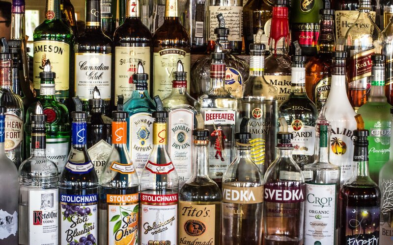 Alcohol Bottles on Shelf — Brown