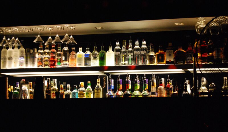 Alcohol Bottles on Shelves — Black