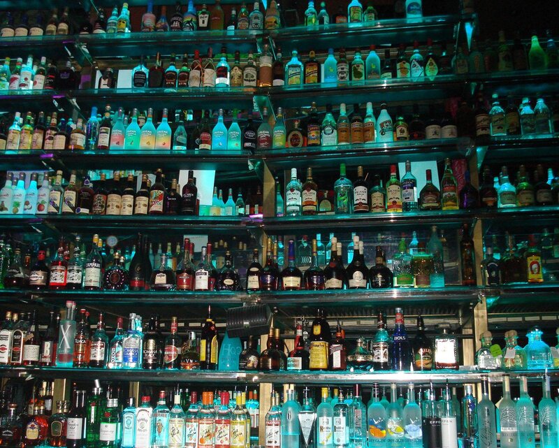Alcohol Bottles on Shelves — Blue