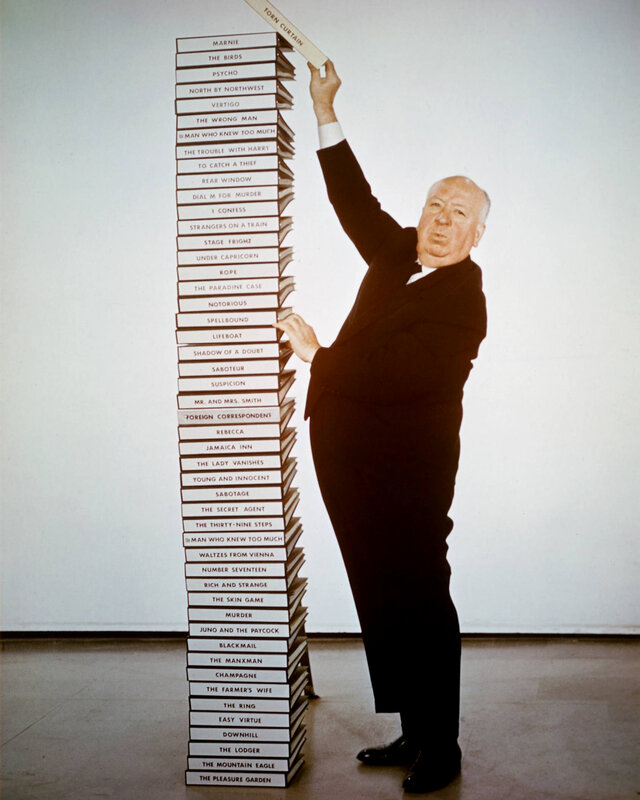 Alfred Hitchcock with book stack